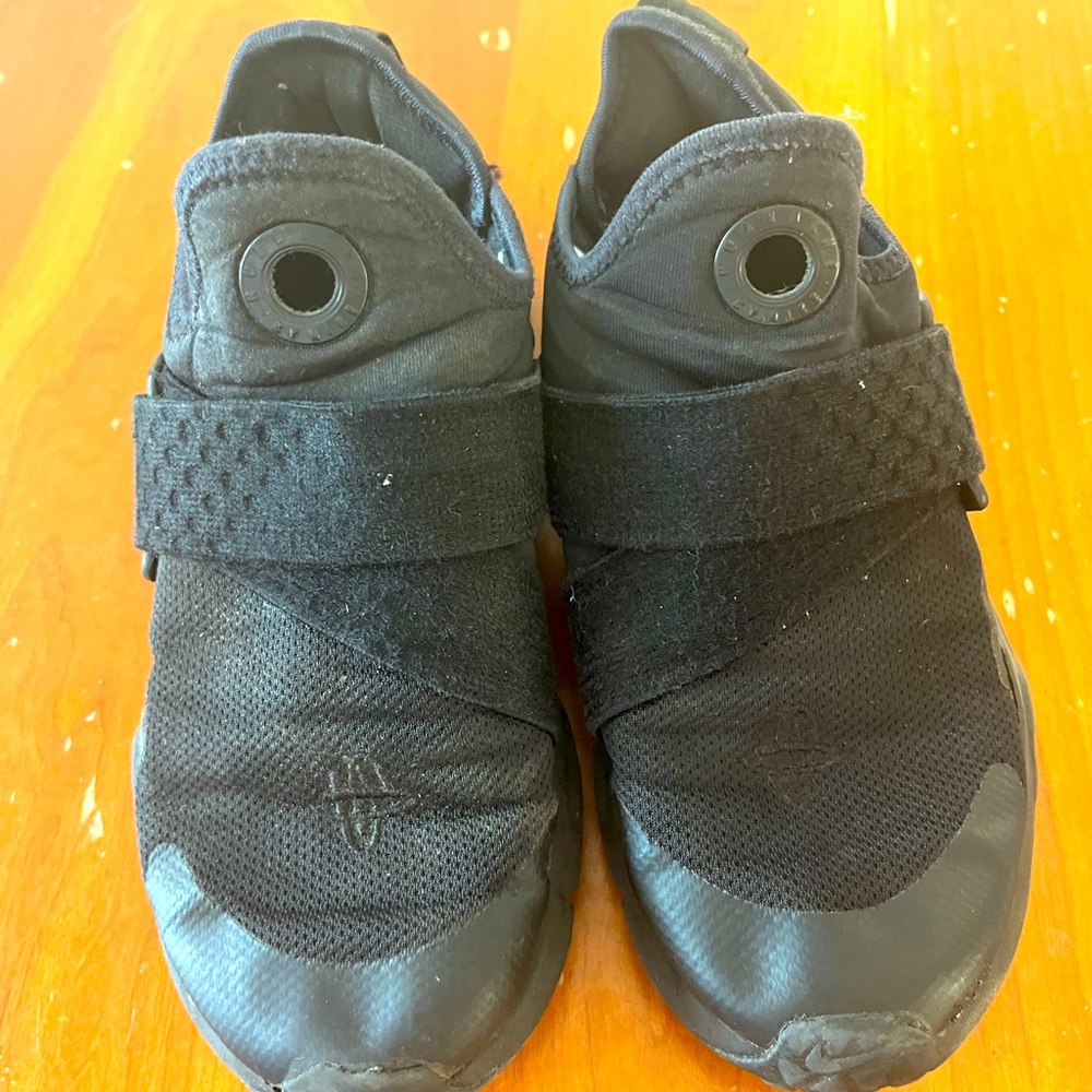 Size one all black slip on boys Nike shoes